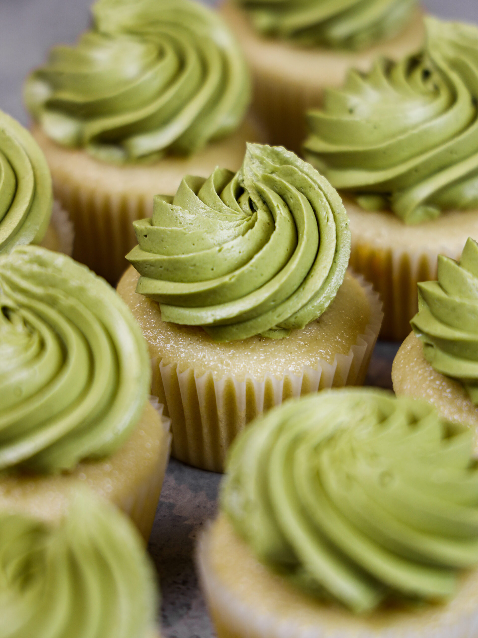 image of vanilla cupcakes frosted with a super smooth, delicious matcha buttercream frosting