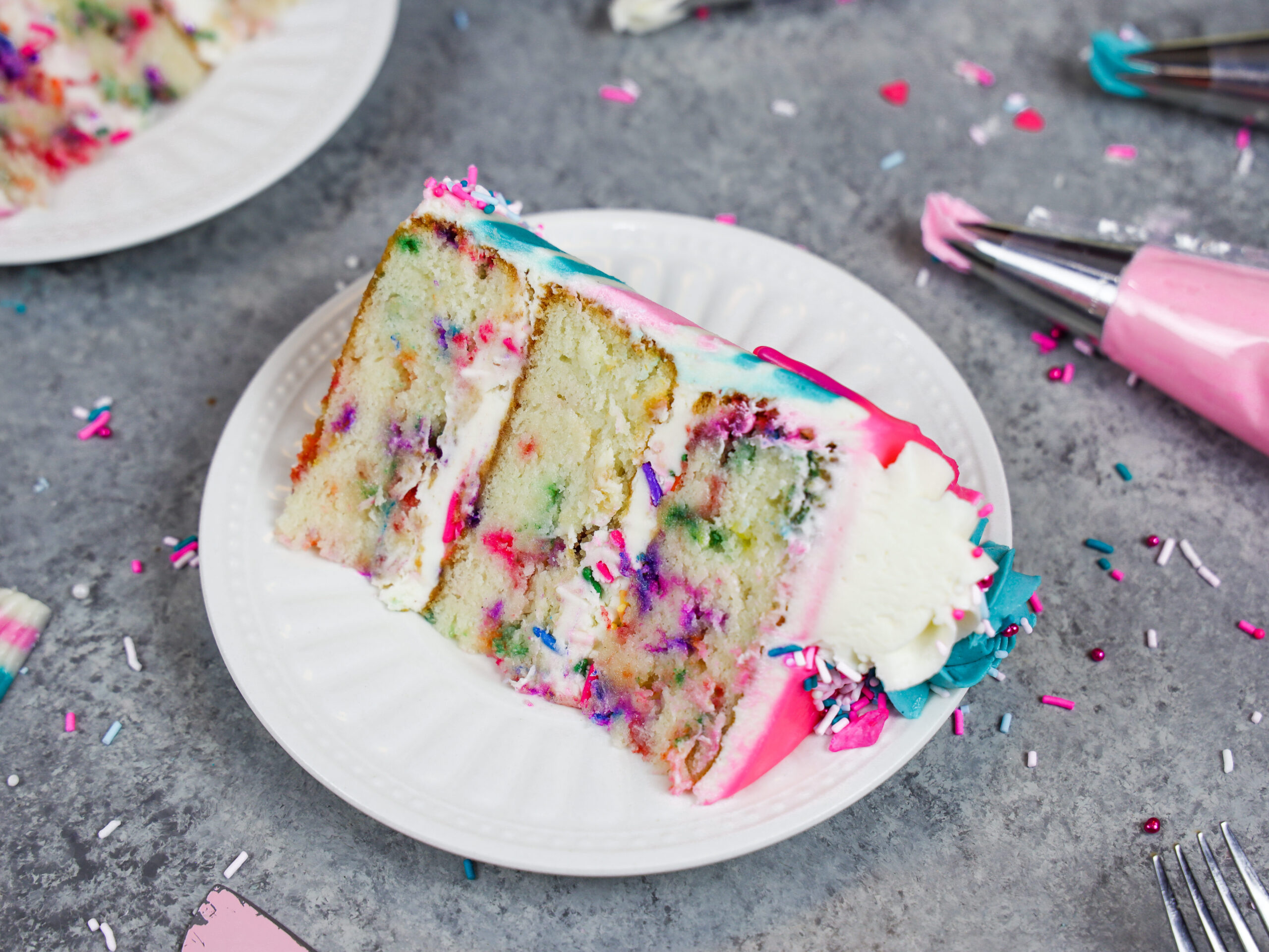 image of a slice of gluten free funfetti cake on a plate ready to be eaten