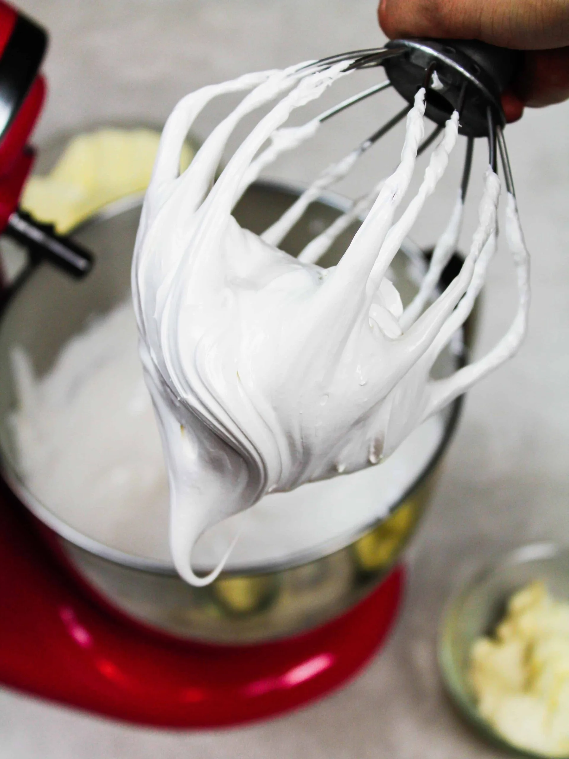 photo of meringue on a kitchenaid whisk attachment, which is about to be turned into swiss meringue buttercream 