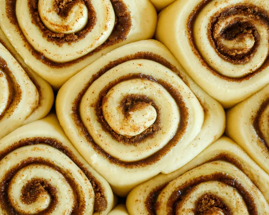 image of quick yeast cinnamon rolls that have risen and are ready to be baked