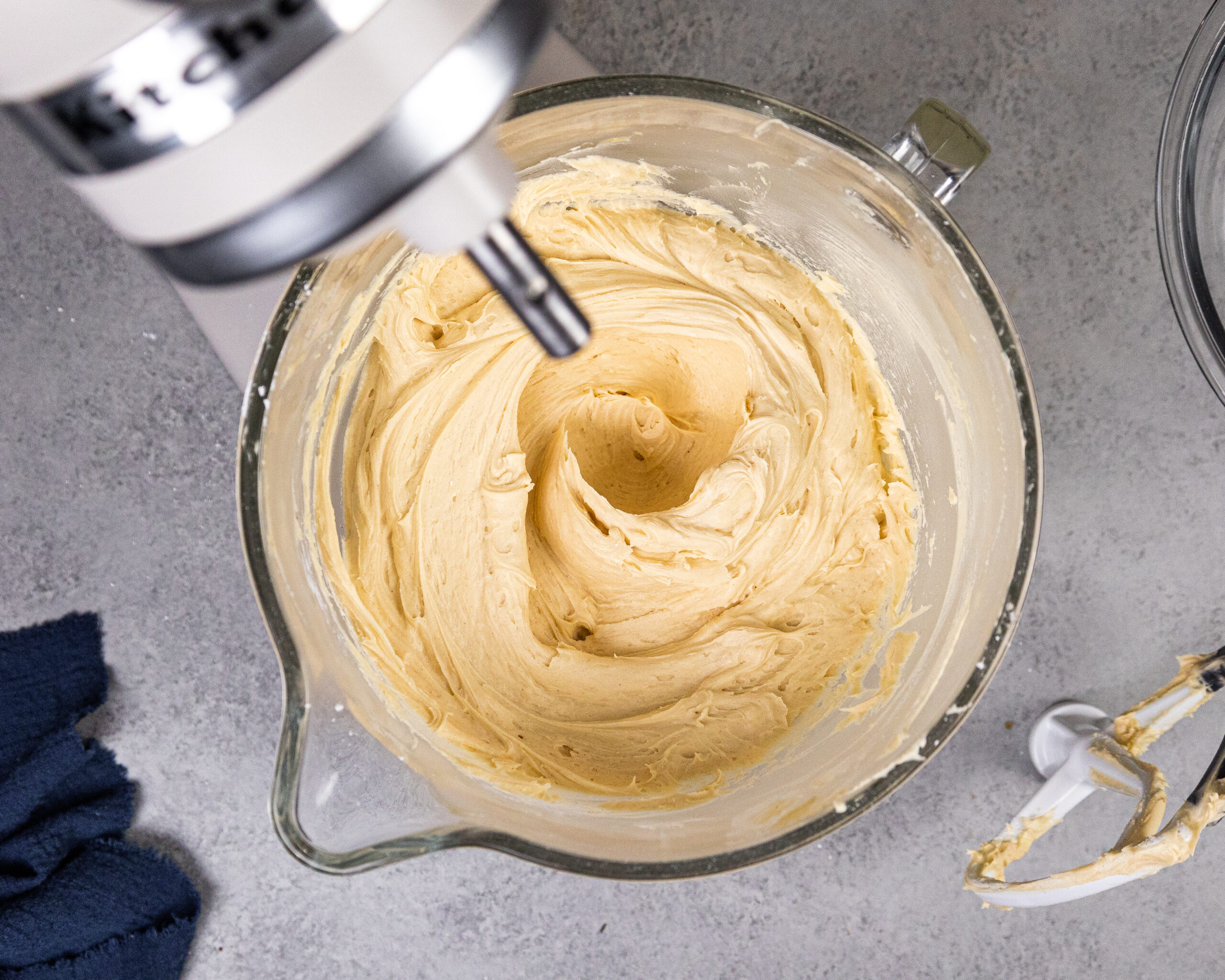 image of creamy peanut butter butter buttercream in the bowl of a kitchenaid stand mixer