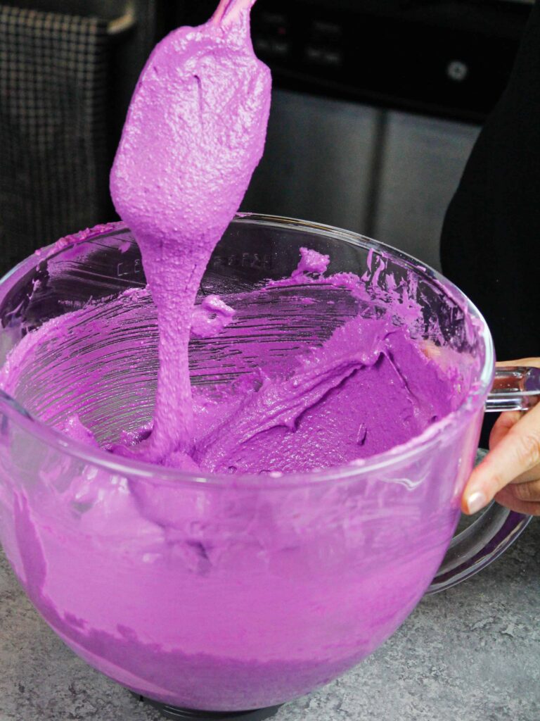 image of purple macaron batter that's ready to be piped