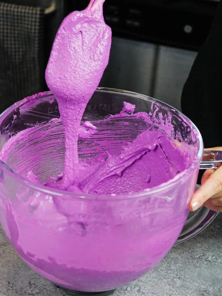 image of purple macaron batter that's ready to be piped