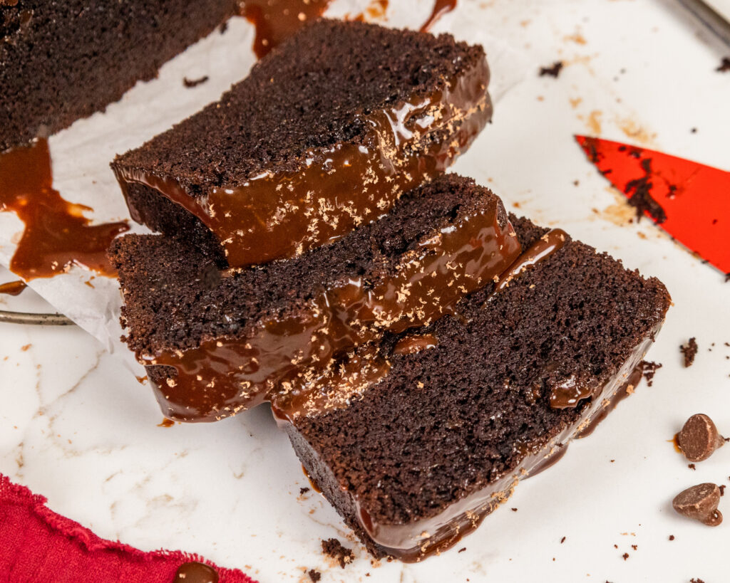 image of slices of a chocolate sour cream pound cake that are topped with a chocolate glaze