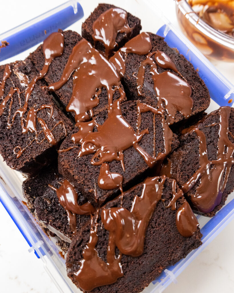 image of slices of chocolate sour cream pound cake that's been placed in an airtight container to store at room temperature