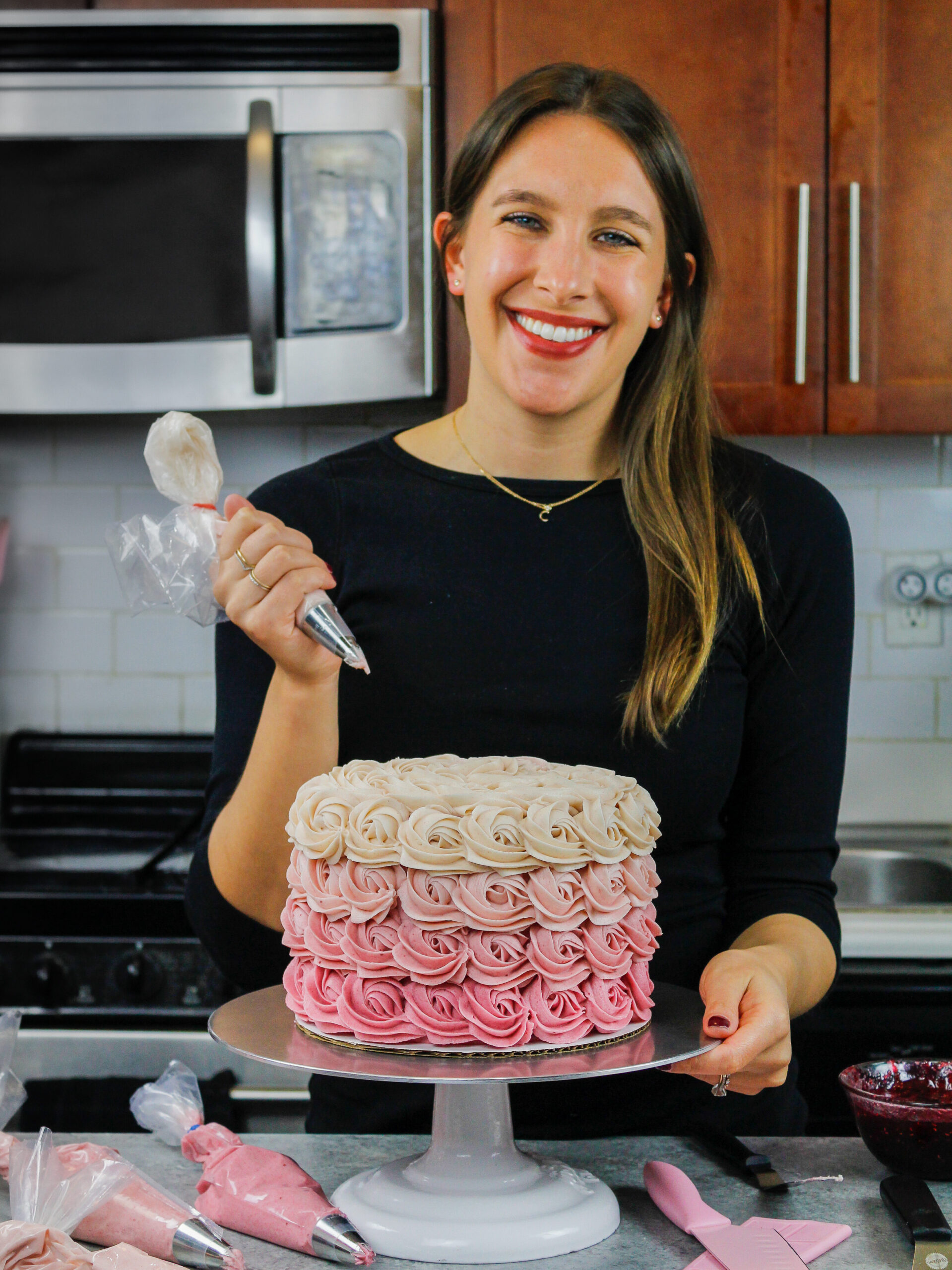 image of chelsey white of chelsweets piping a pink ombre rosette cake