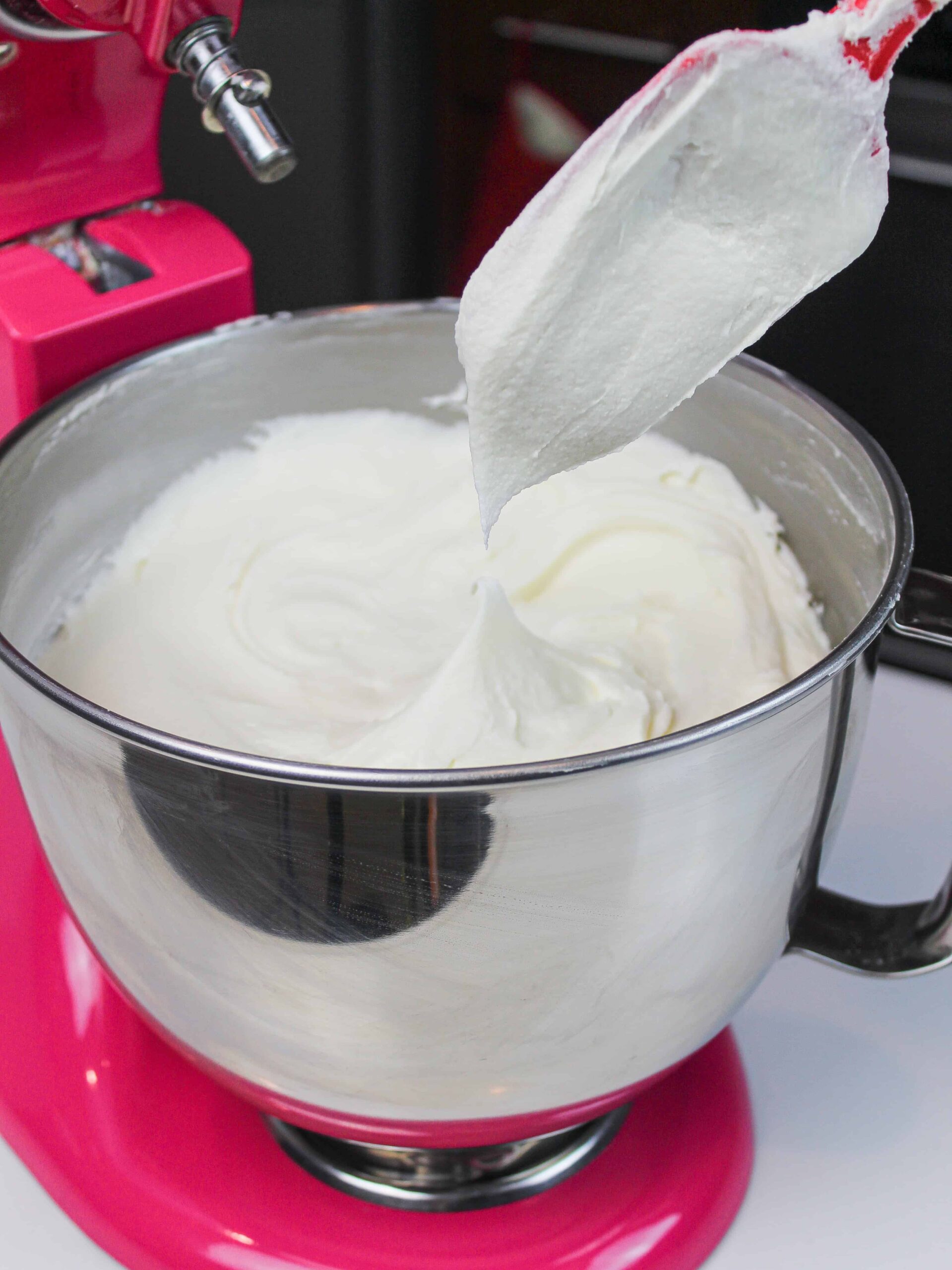 image of buttercream frosting being tested for the right consistency with the spatula test
