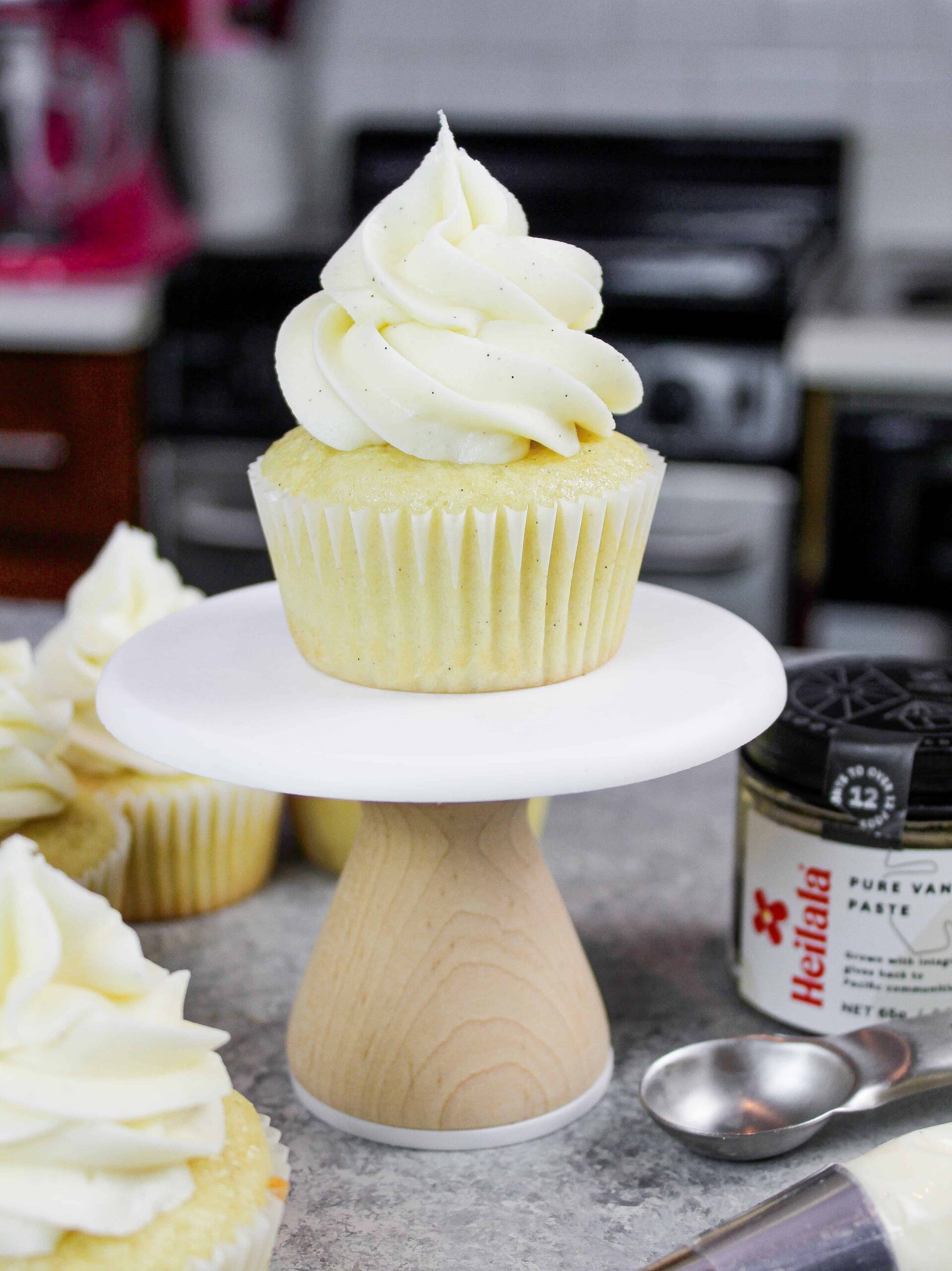 image of gluten free vanilla cupcake frosted with buttercream icing on mini cupcake stand