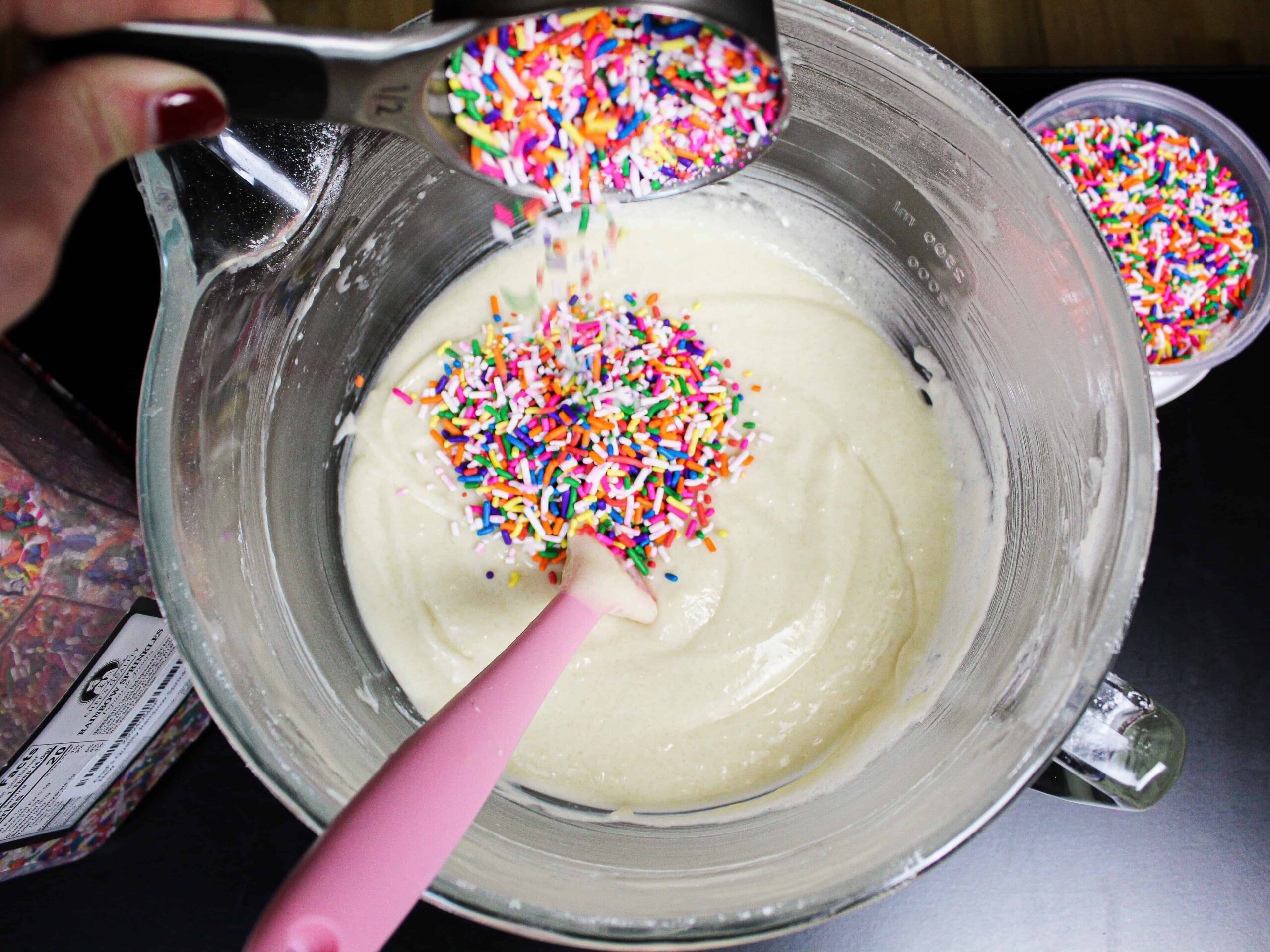 image of adding the right type of rainbow sprinkles into funfetti cake batter