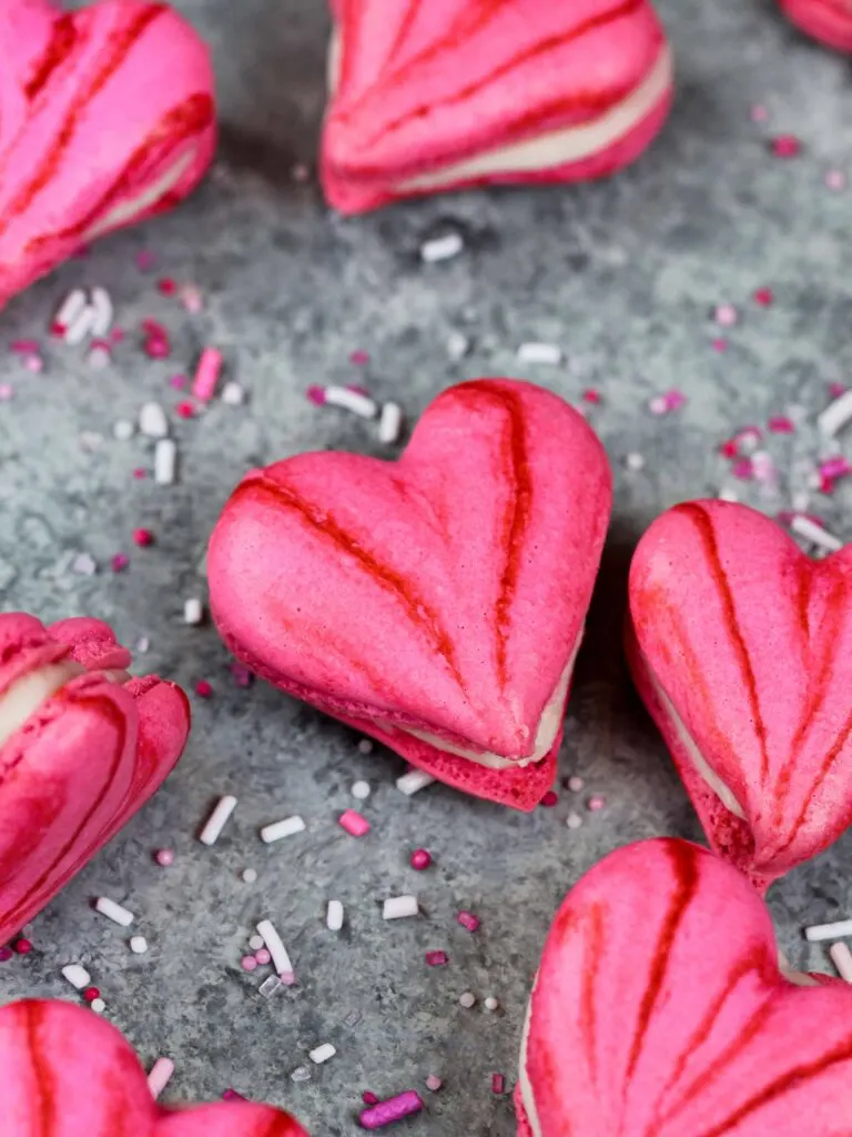 image of pink heart shaped macarons filled with buttercream