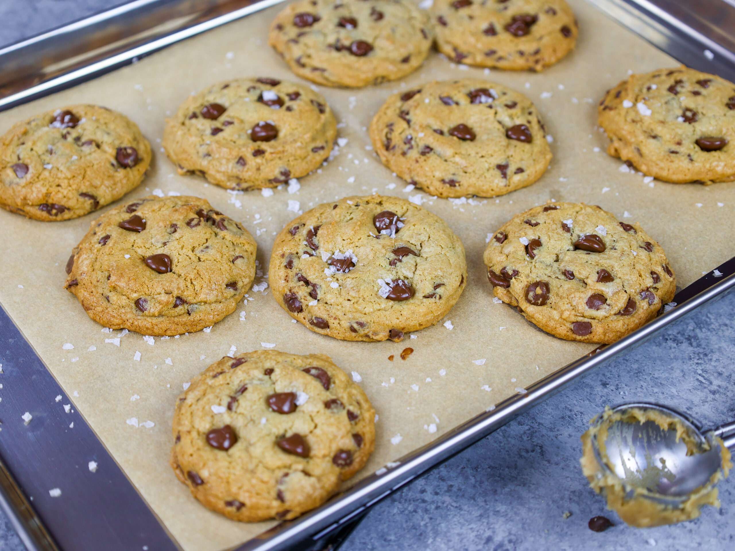 image of cream cheese chocolate chip cookies that have been baked until golden brown and sprinkled with flakey sea salt