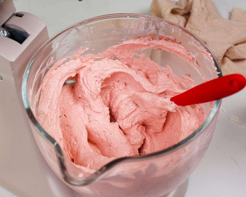 image of strawberry swiss meringue buttercream that's mixed and ready to be used