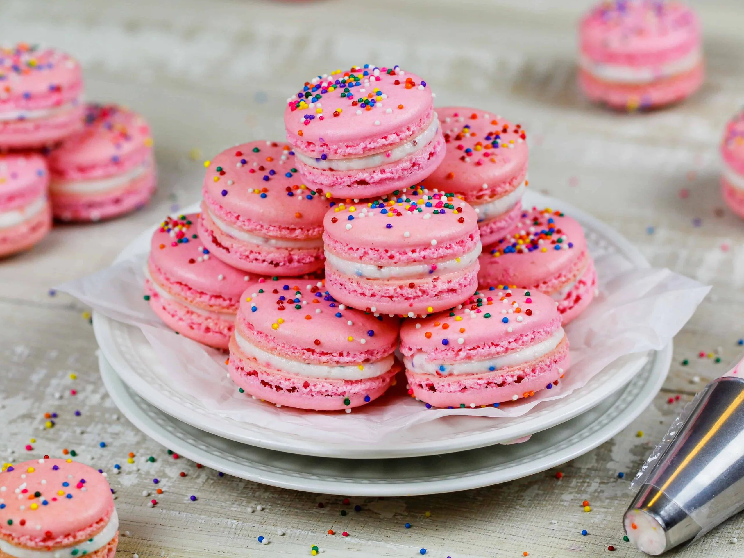 image of birthday cake macarons stacked on a plate