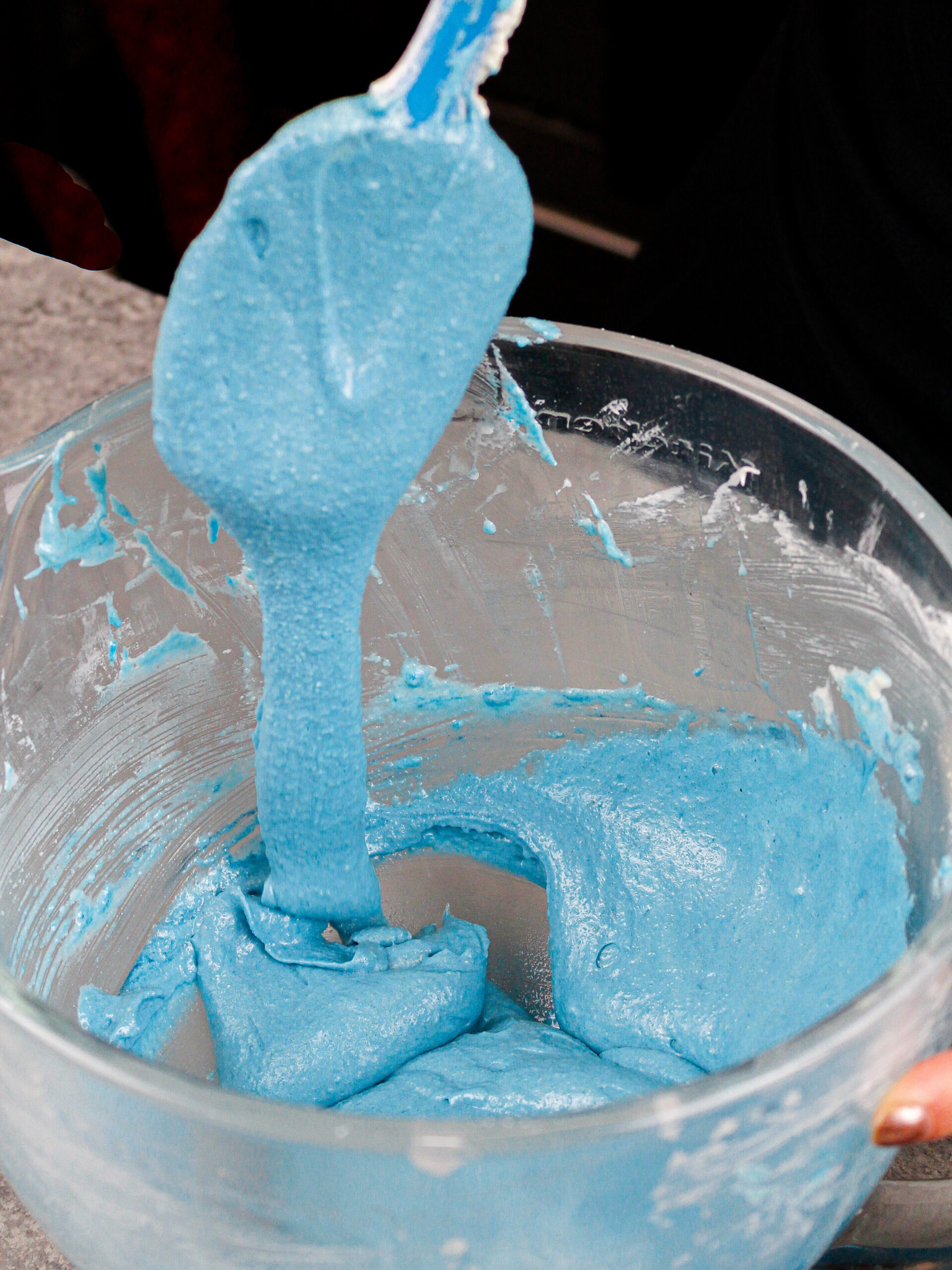image of blueberry blue colored macaron batter that's been mixed to just the right consistency and is ready to be piped