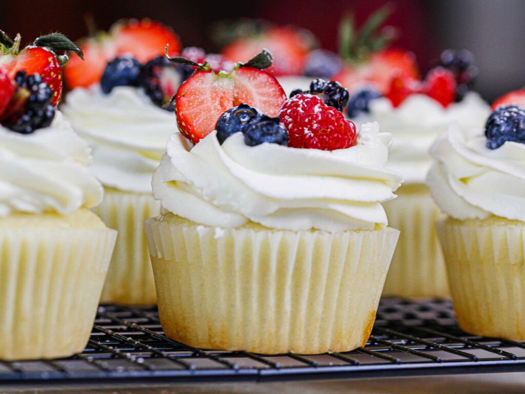 image of cupcakes topped with mascarpone cream frosting and fresh fruit