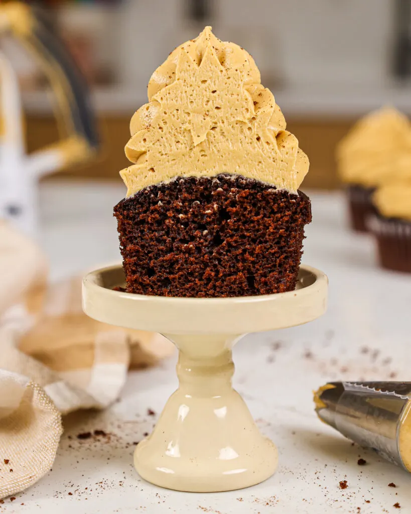 image of a chocolate cupcake that's been cut open and is frosted with espresso buttercream frosting