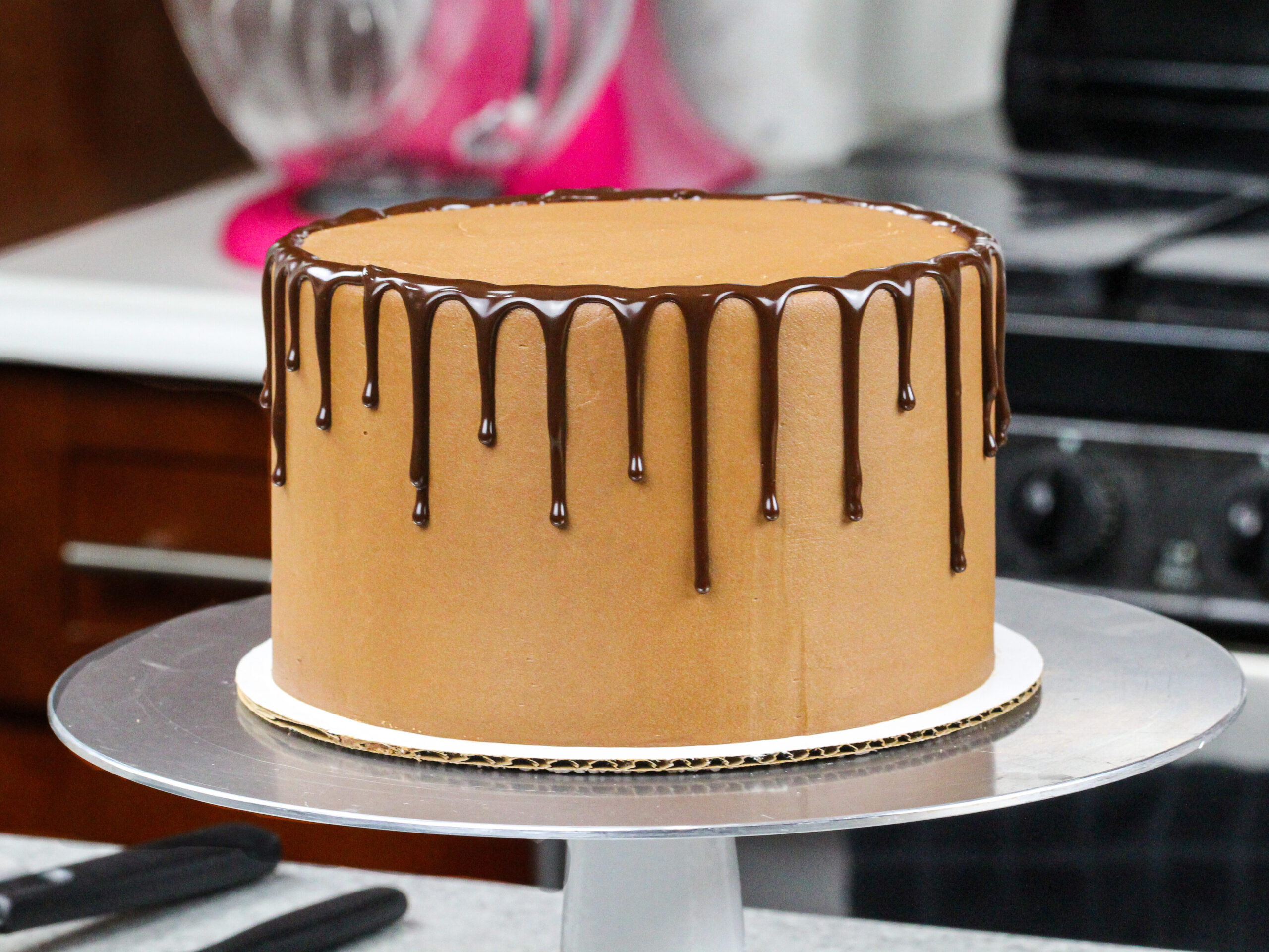 image of chocolate ganache drips added around a chocolate cake