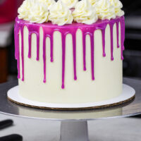image of a purple drip cake made with a colorful white chocolate ganache