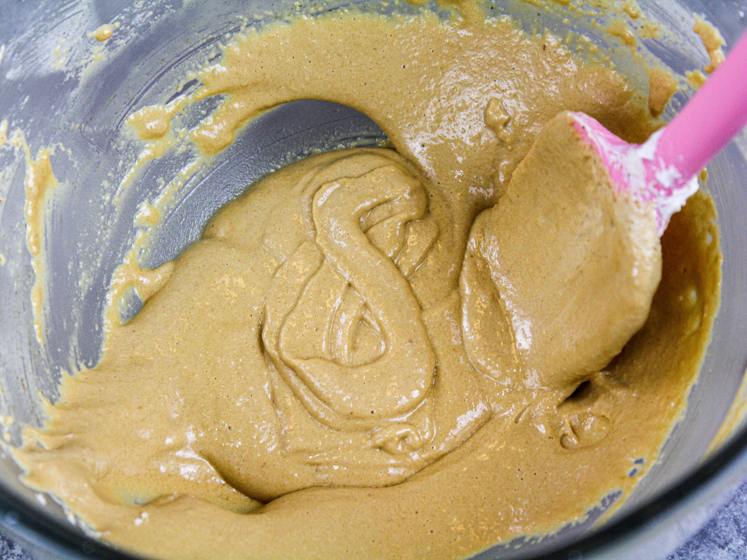image of coffee macaron batter that has passed the figure 8 test and has been mixed to the right consistency