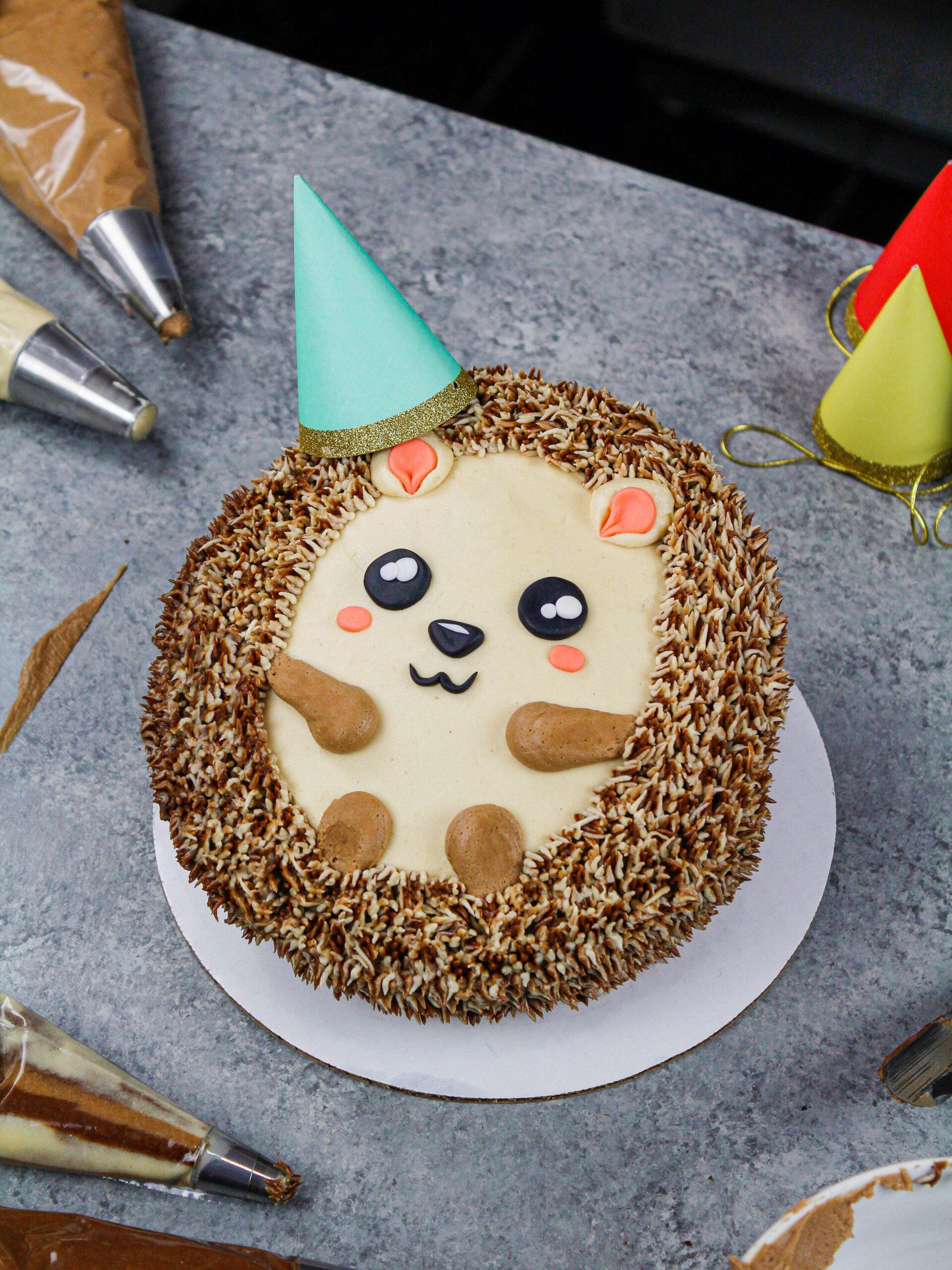 image of an adorable and easy to make hedgehog cake made with chocolate cake layers and buttercream frosting