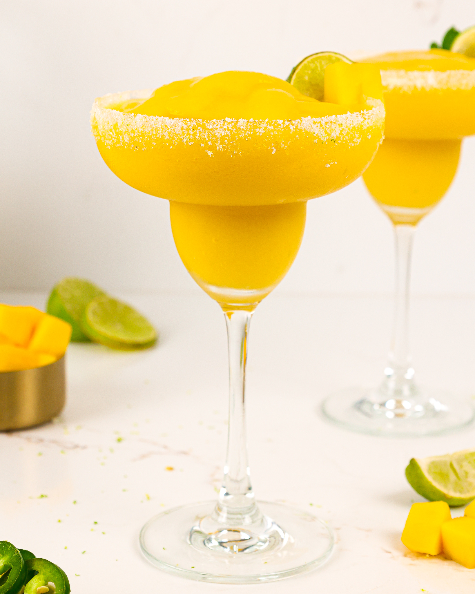 image of frozen mango margaritas blended in a blender that are smooth, creamy, and perfectly sweet and spicy