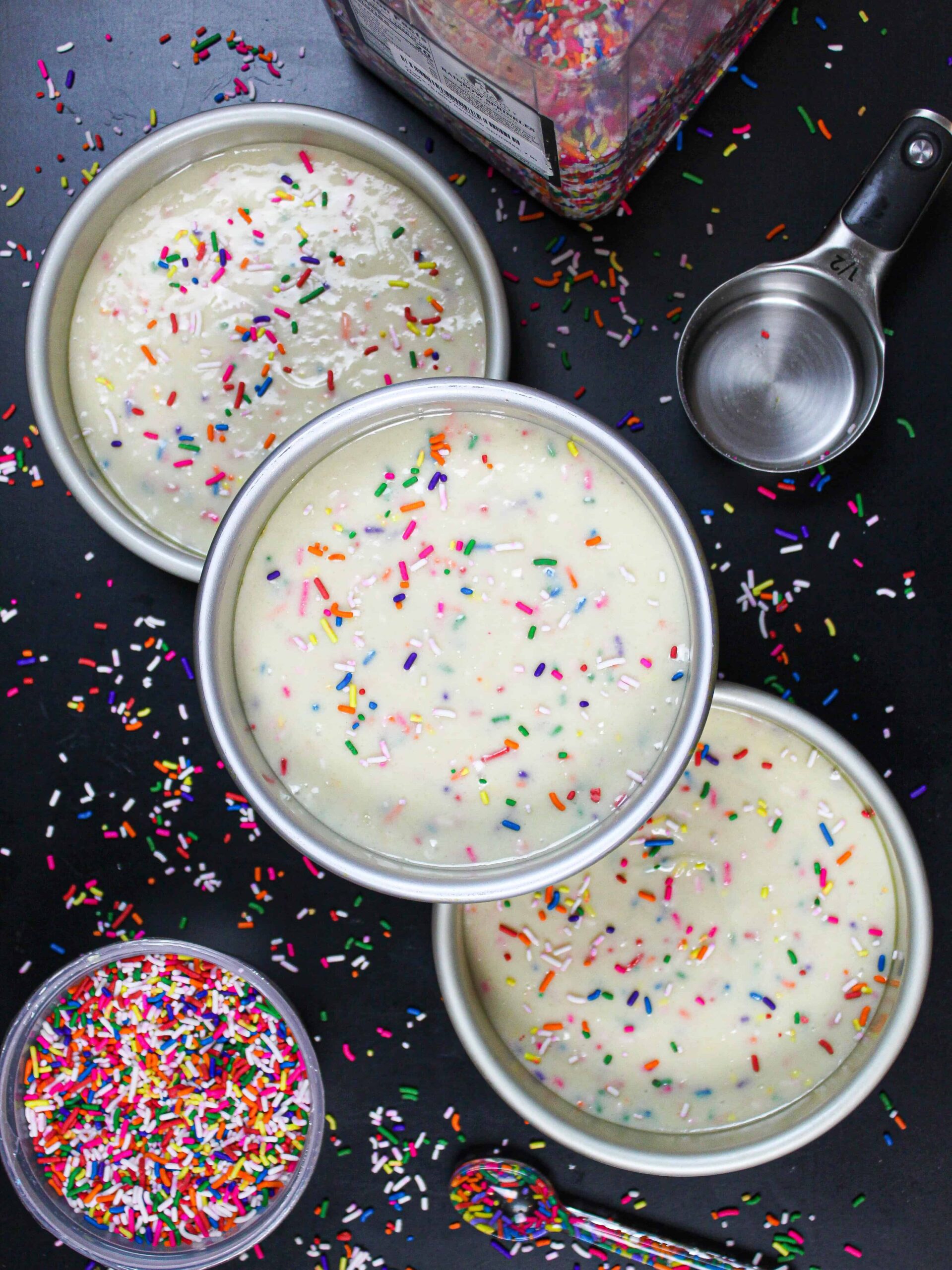 image of funfetti cake batter in 6 inch cake pans, ready to be baked