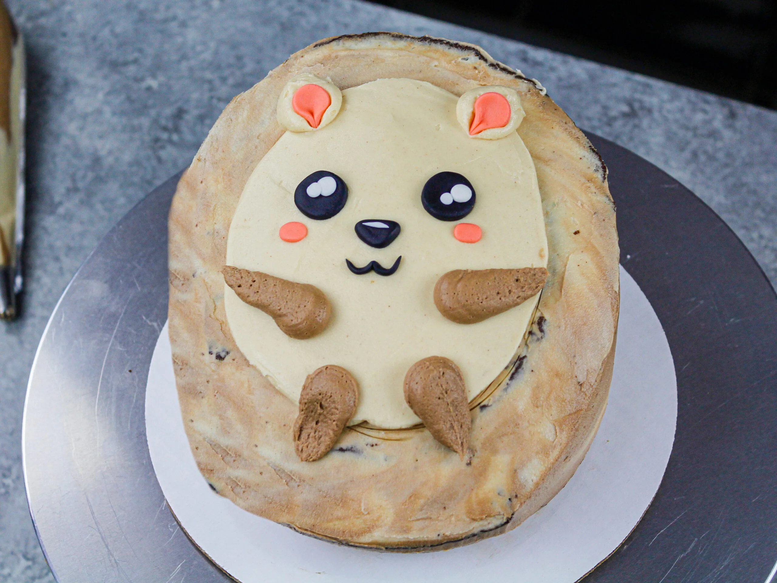 image of a partially decorated hedgehog cake that just needs to have it's buttercream quills piped on