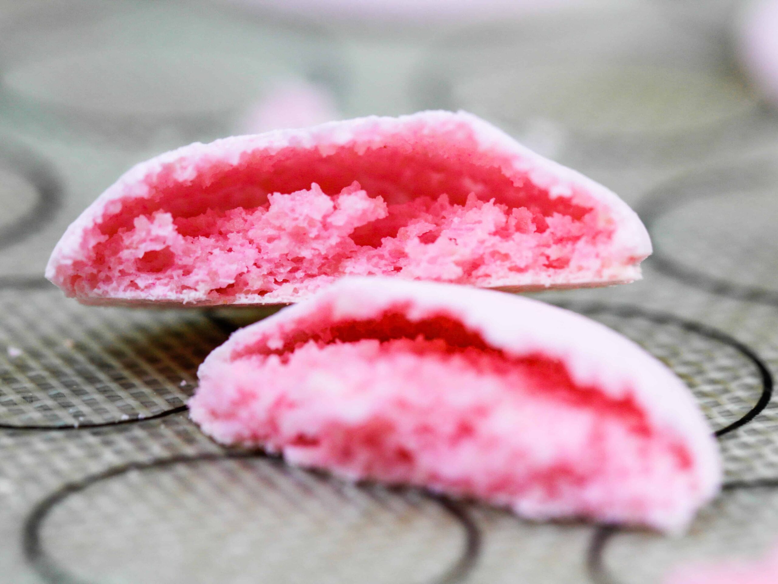 image of hollow italian macarons that were not banged against a counter before being baked included in a macaron troubleshooting guide explaining how to avoid this issue