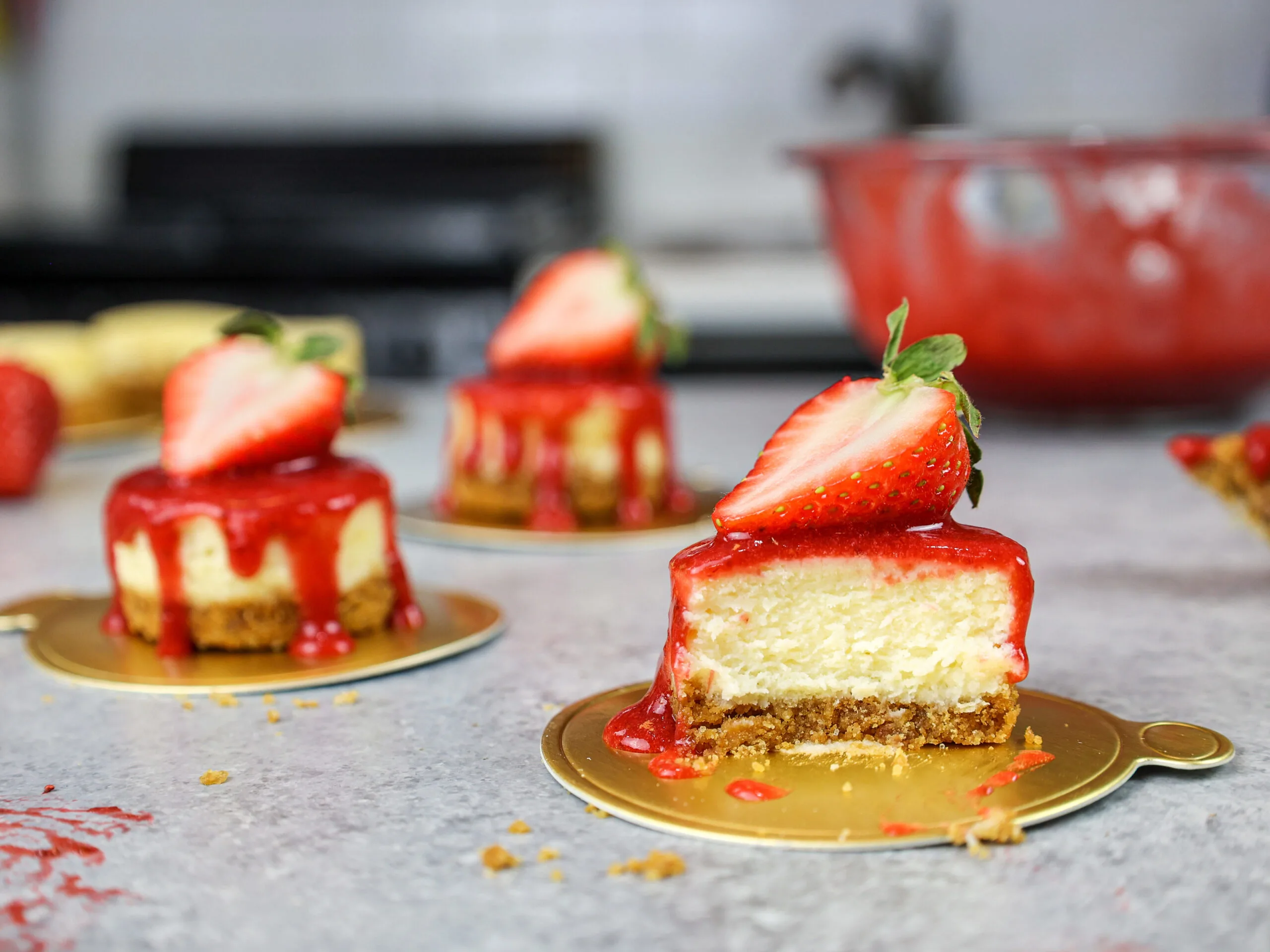 image of a mini strawberry cheesecake that's been cut into to show how creamy and fluffy it is