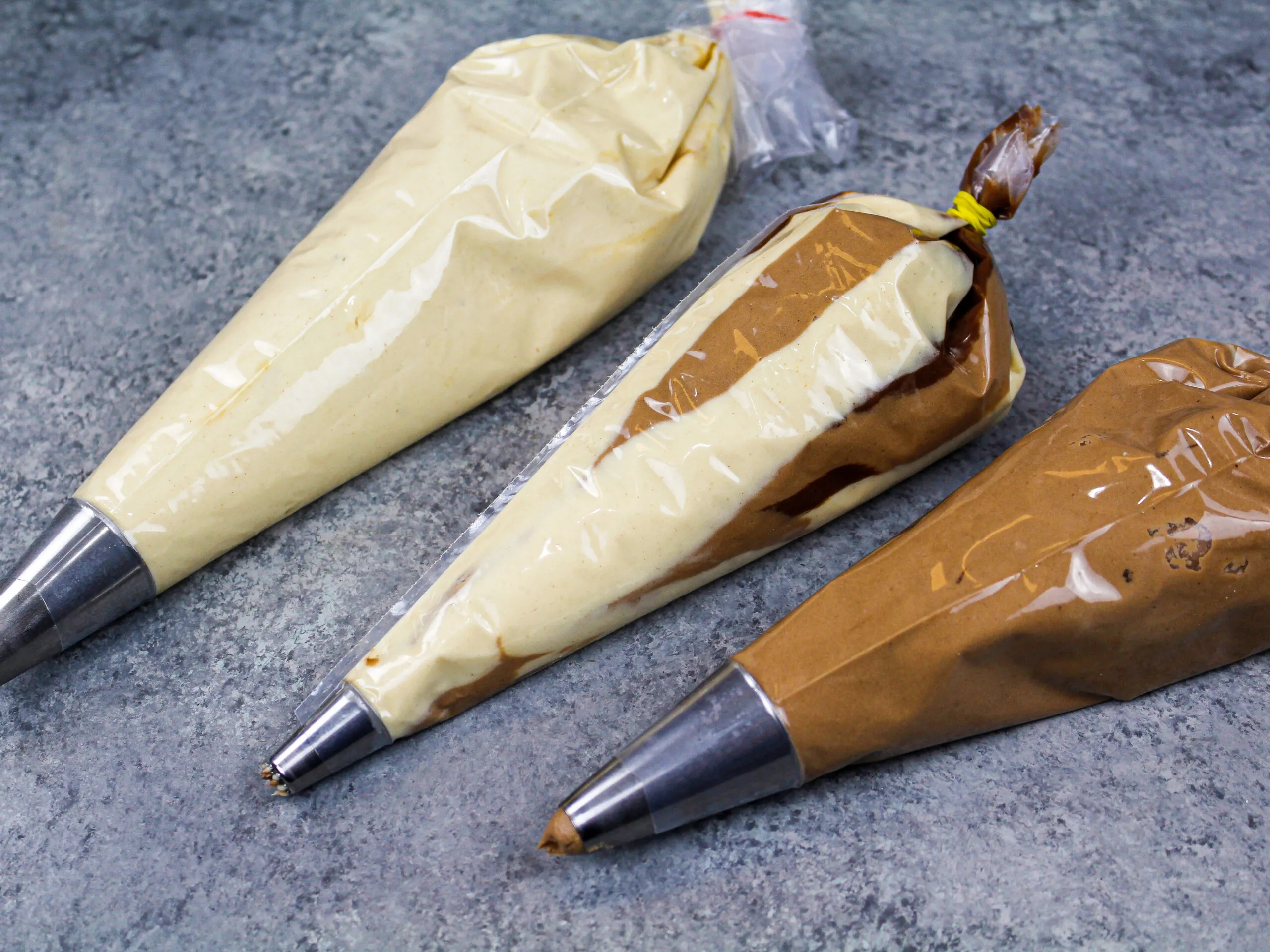image of peanut butter chocolate buttercream frosting in piping bags
