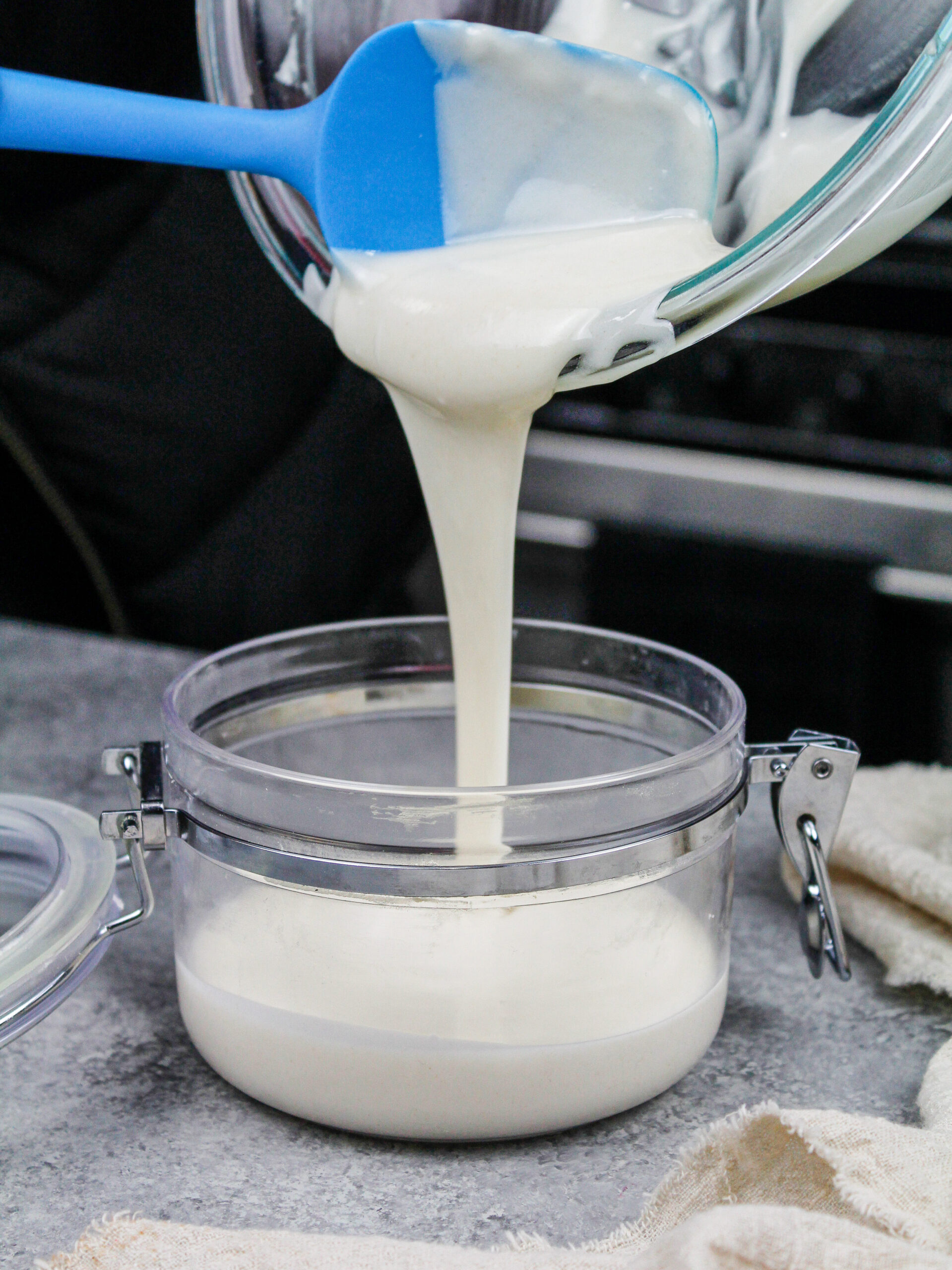 image of homemade cake goop being poured into an airtight container