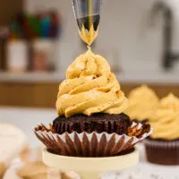 image of a cupcake being frosted with coffee buttercream frosting