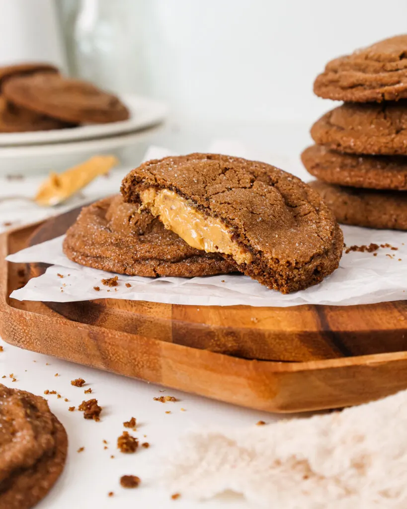 image of chocolate peanut butter stuffed cookies that have been cut in half to show the peanut butter filling