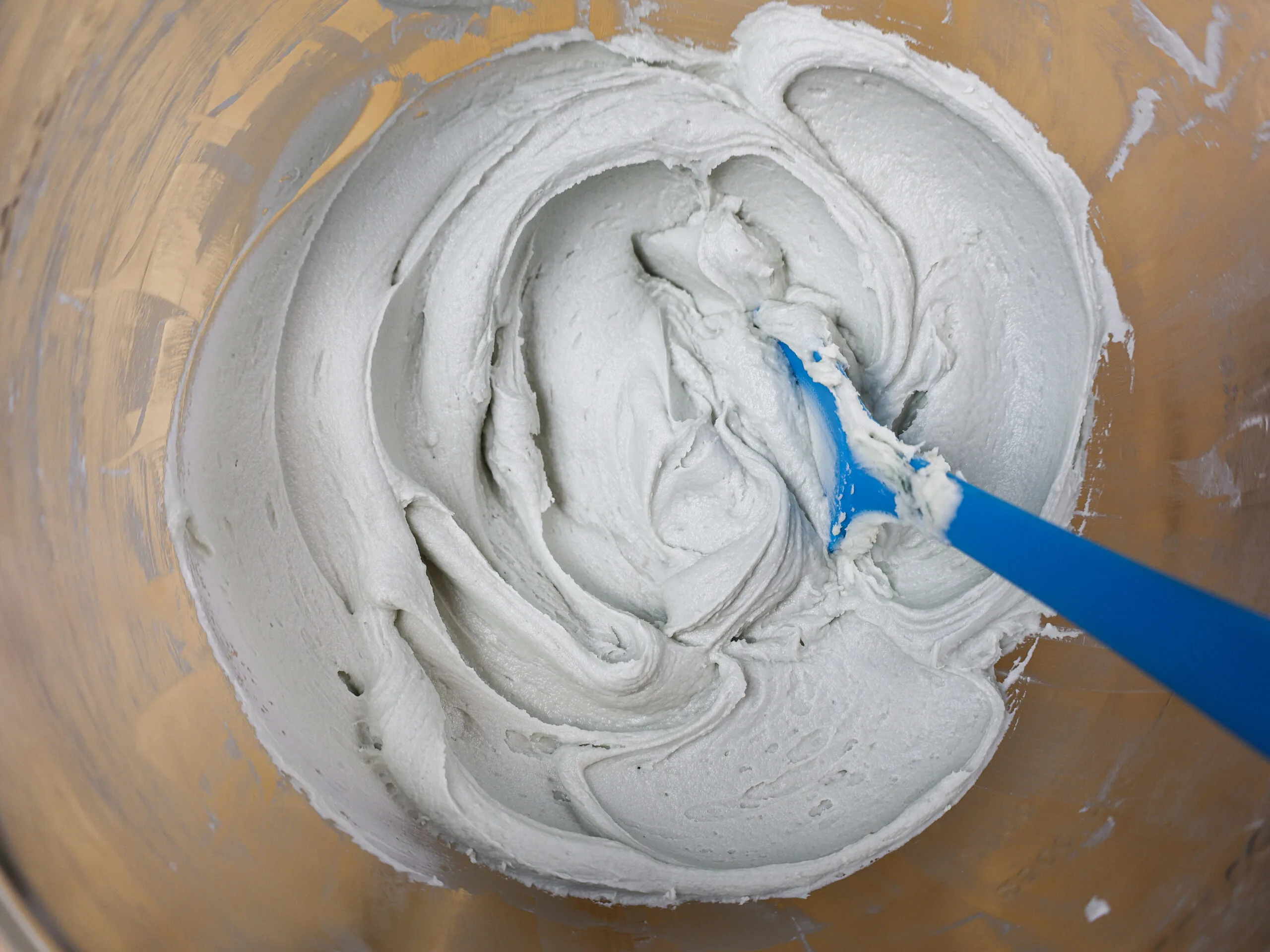 image of grey buttercream frosting in a bowl