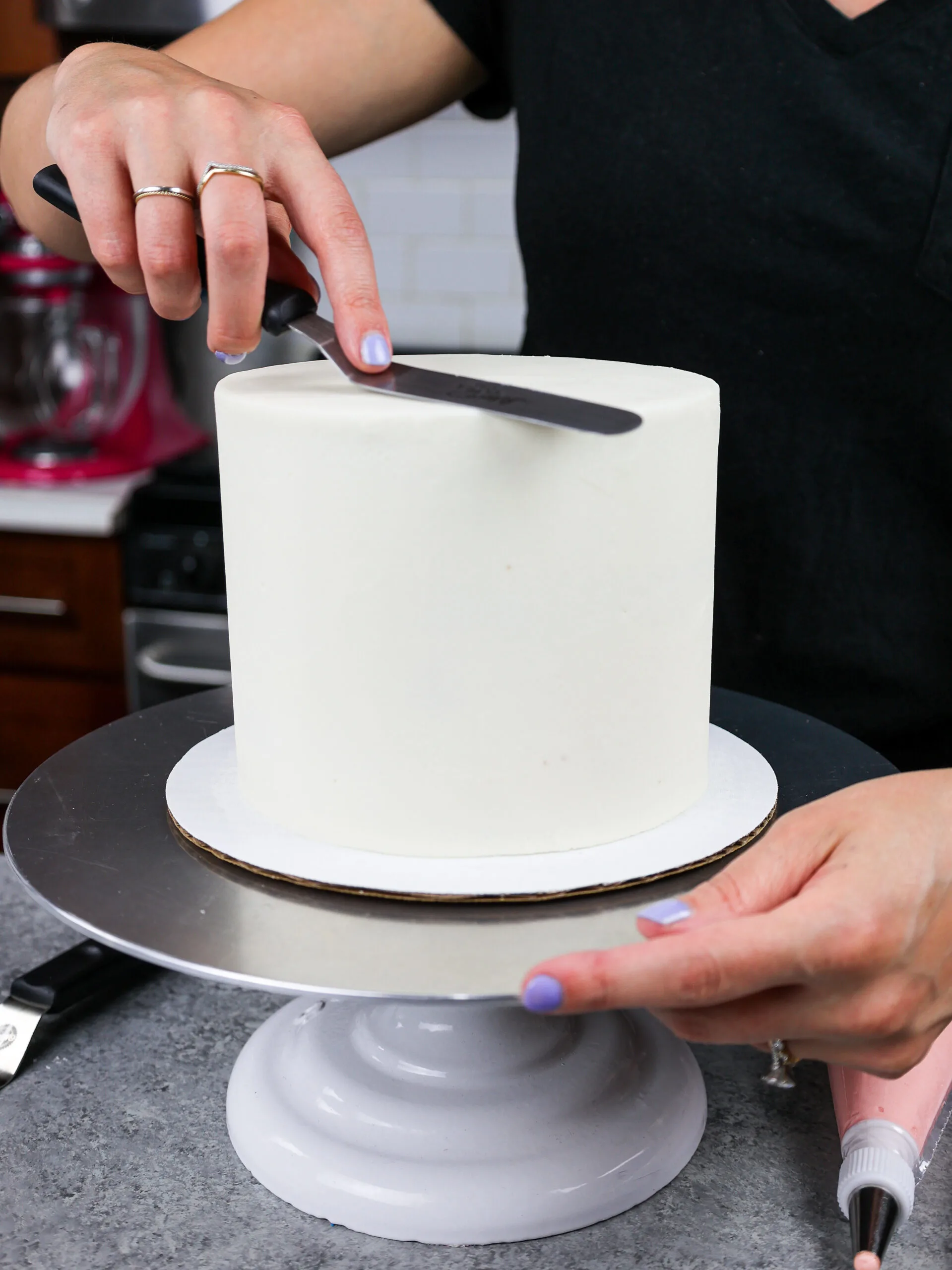image a 6-inch layer cake that has perfectly smooth buttercream frosting