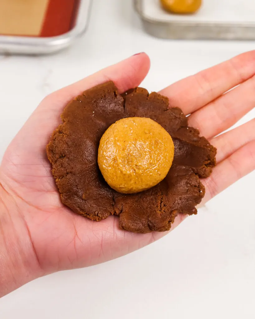 image of chocolate cookie dough being filled with a chilled peanut butter filling