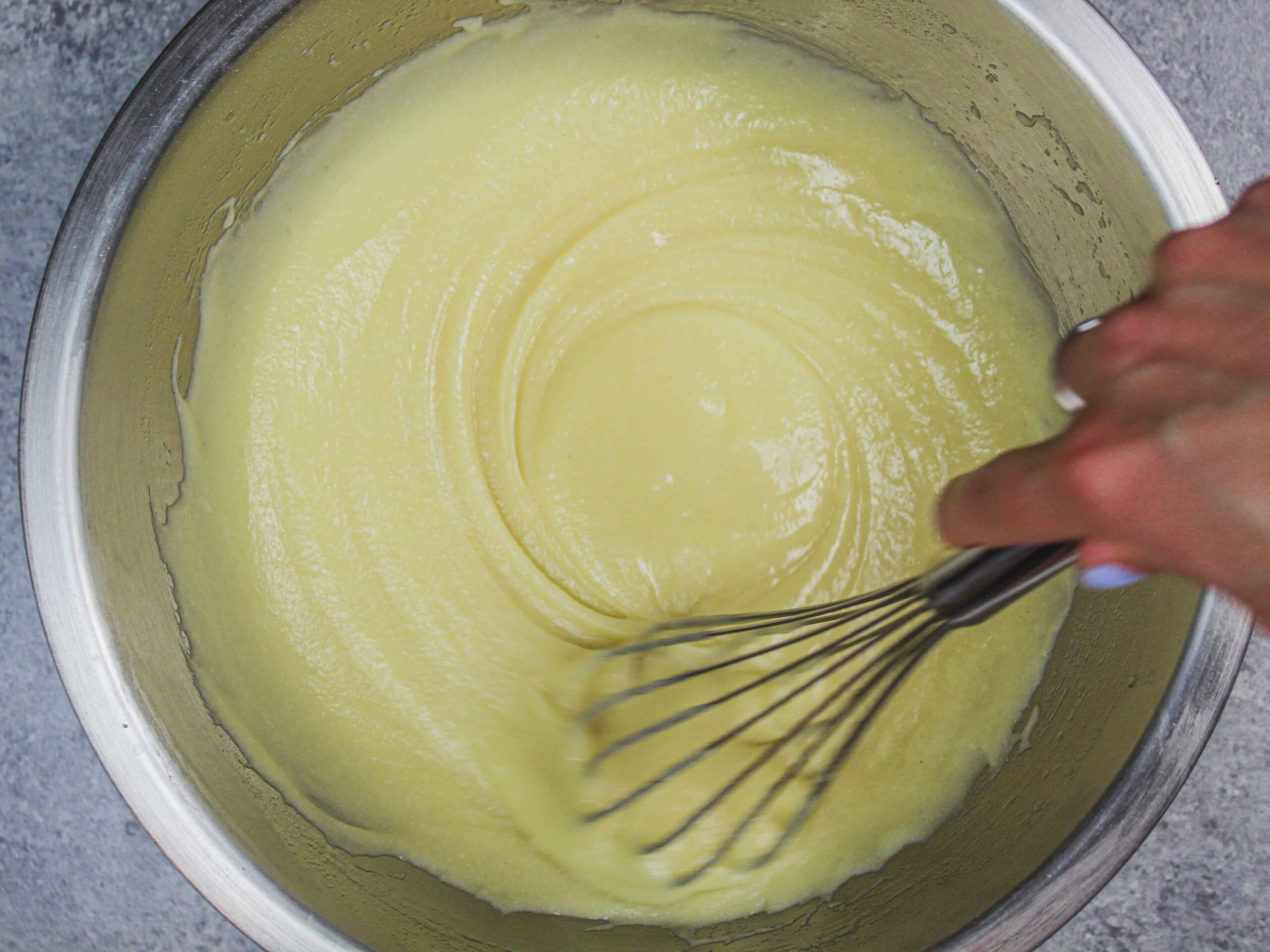 image of gluten free cake batter being overstirred to help give it the structure it needs