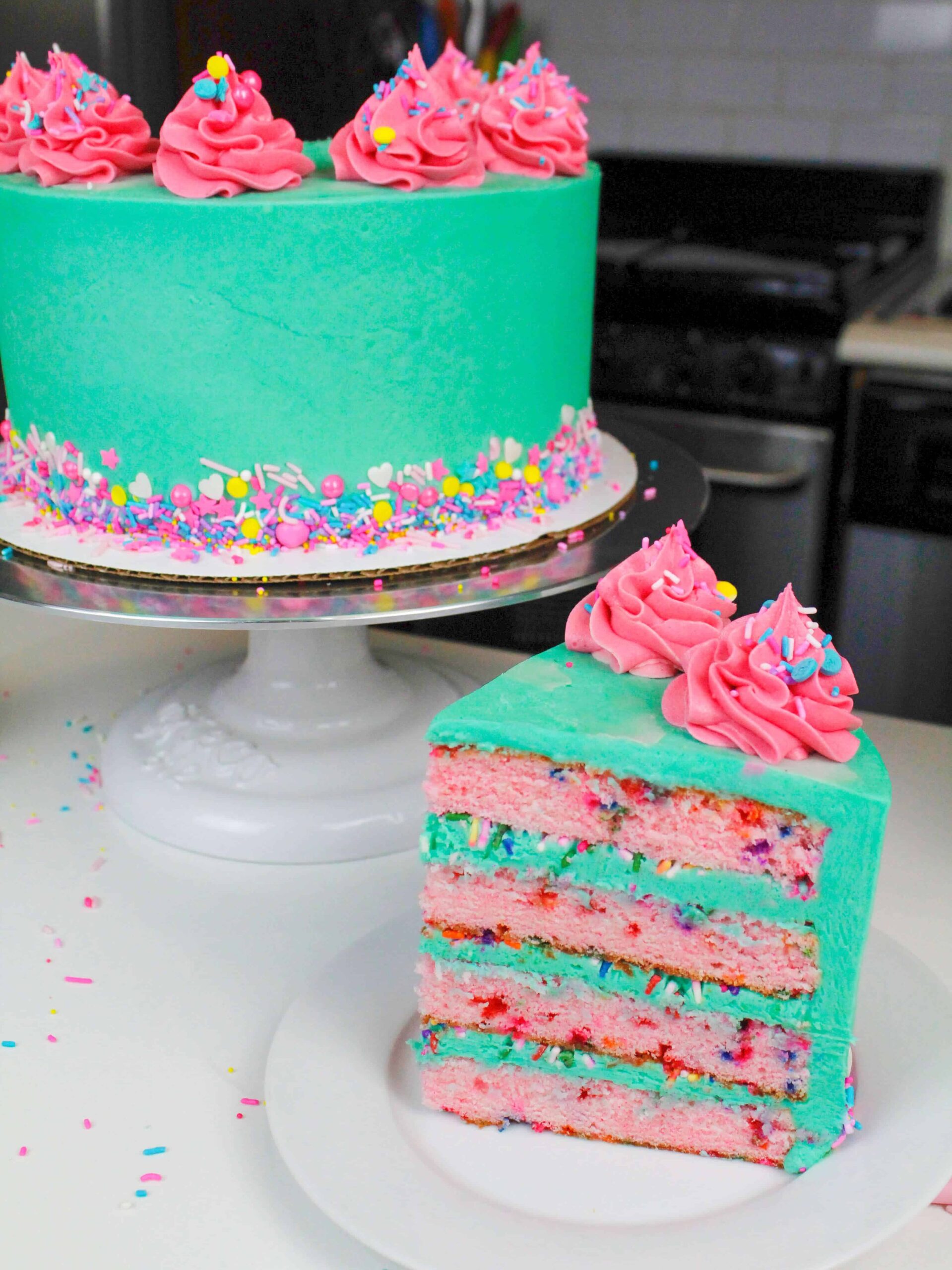 Sliced funfetti cake, with bright blue frosting