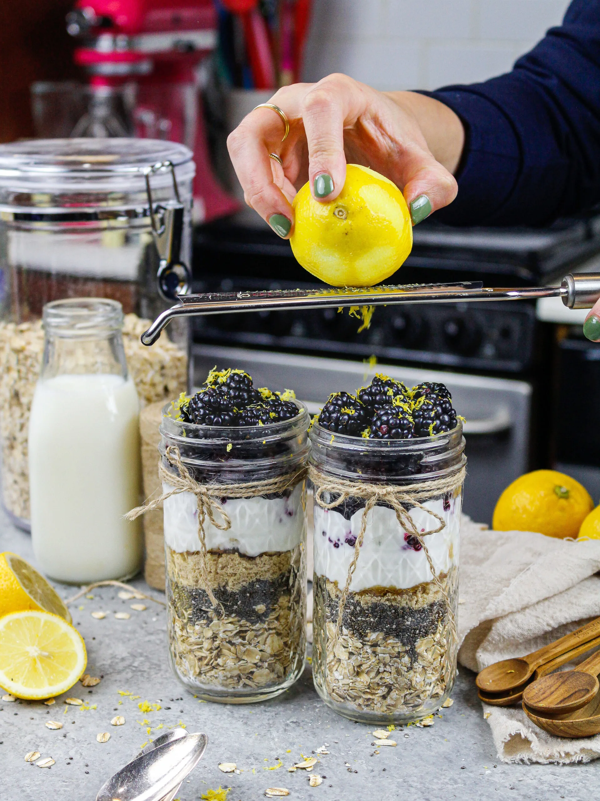 image of a lemon being zested into blackberry overnight oats
