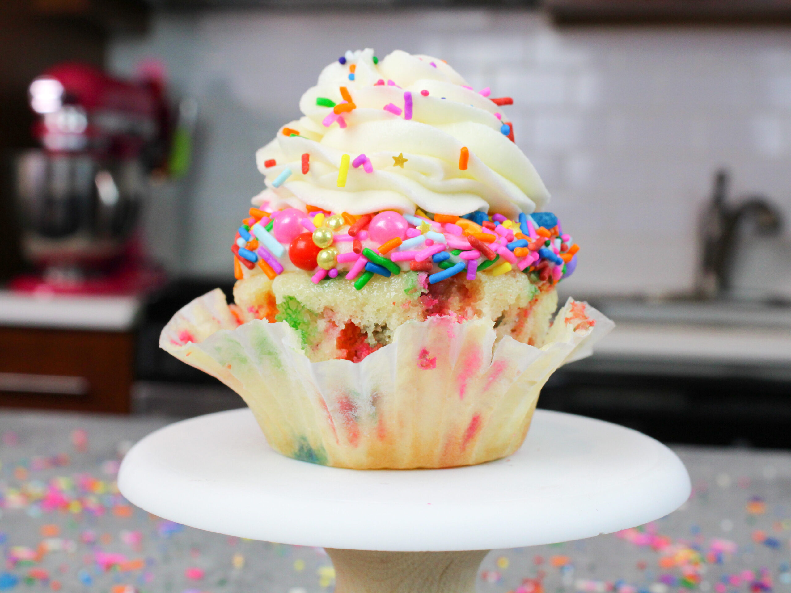 image of a cupcake that was made using a funfetti cupcake recipe and that has been decorated with cute sprinkles