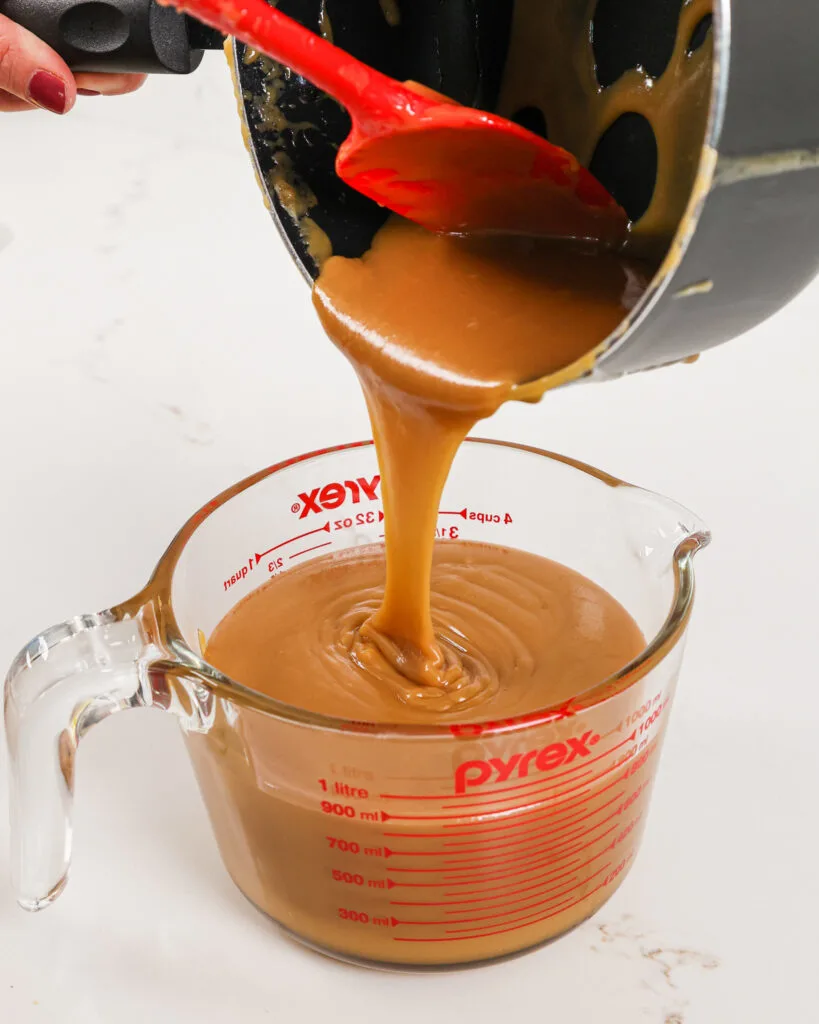image of thick caramel filling being poured into a separate container to cool