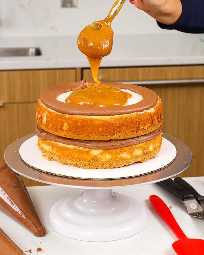 image of thick caramel filling being added into a cake to make a Twix flavored cake