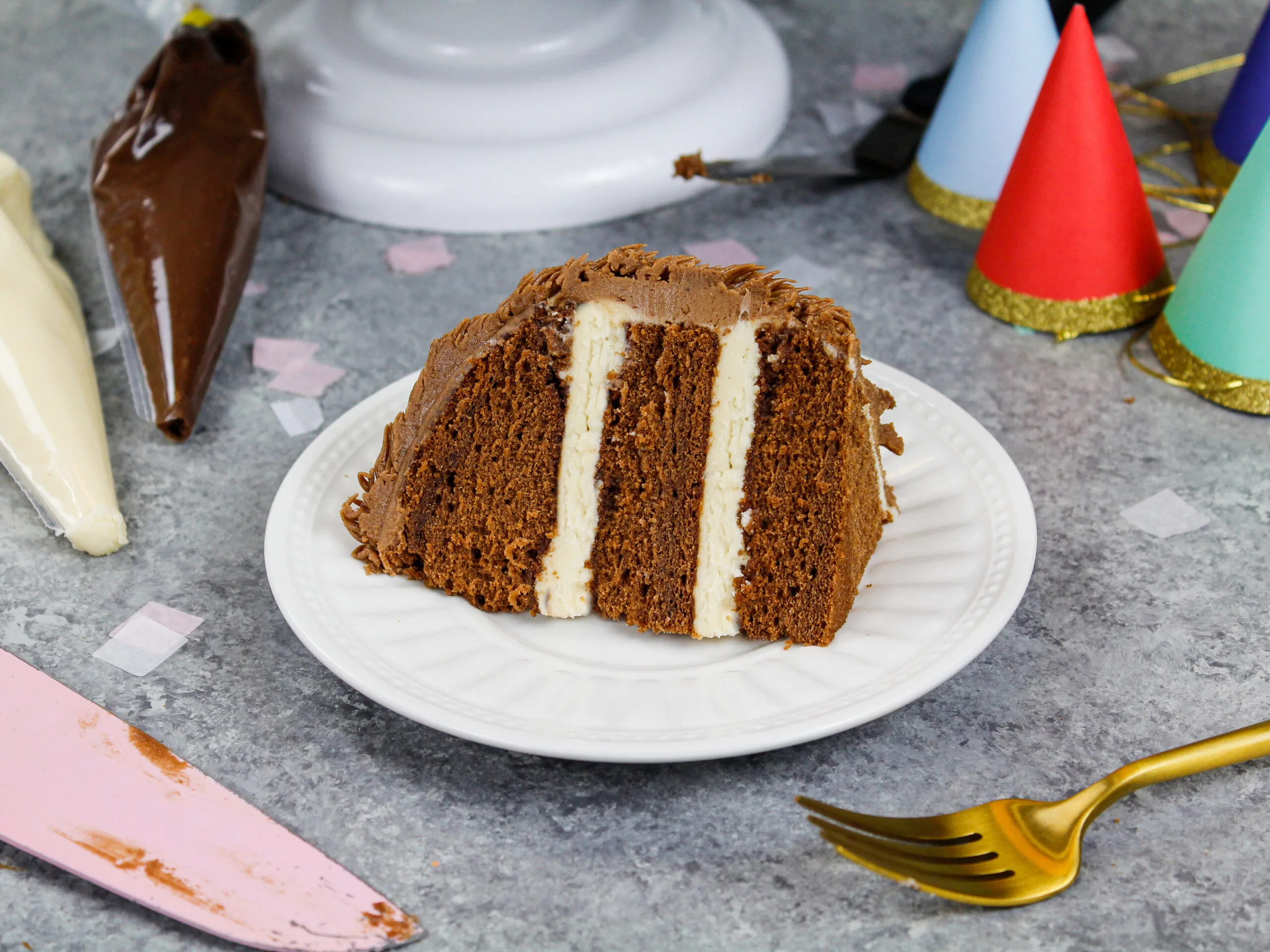 image of a slice of chocolate cake filled with peanut butter buttercream that's been cut from a sloth cake