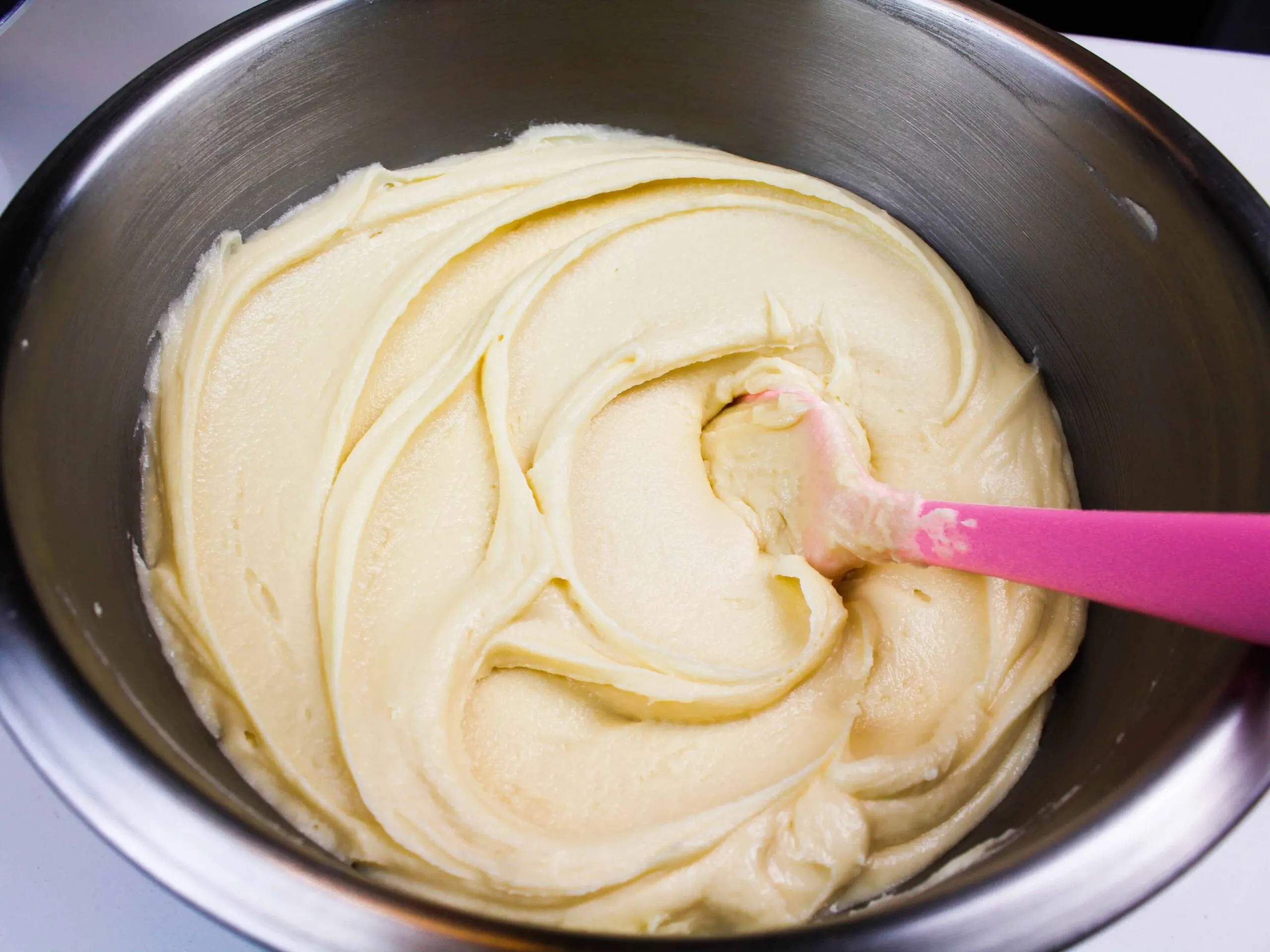 image of a batch of super smooth air bubble free frosting that has been stirred by hand