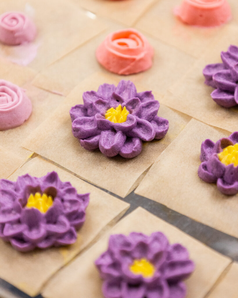 image of buttercream chrysanthemums that have been piped and are ready to be frozen in the freezer