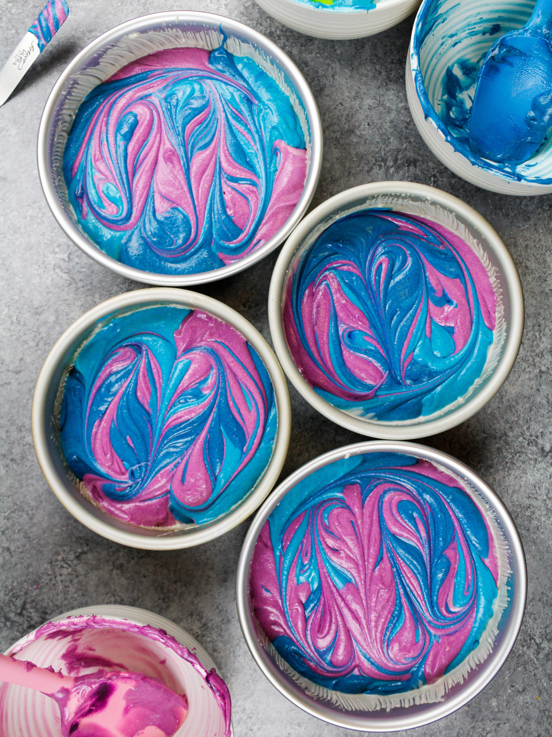 image of colorful swirled cake layers made with purple and blue cake batter