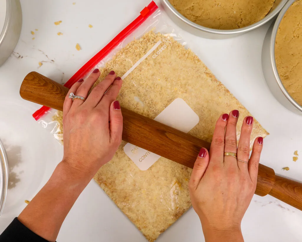 image of shortbread cookies being crushed to make a shortbread crust for a twix cake