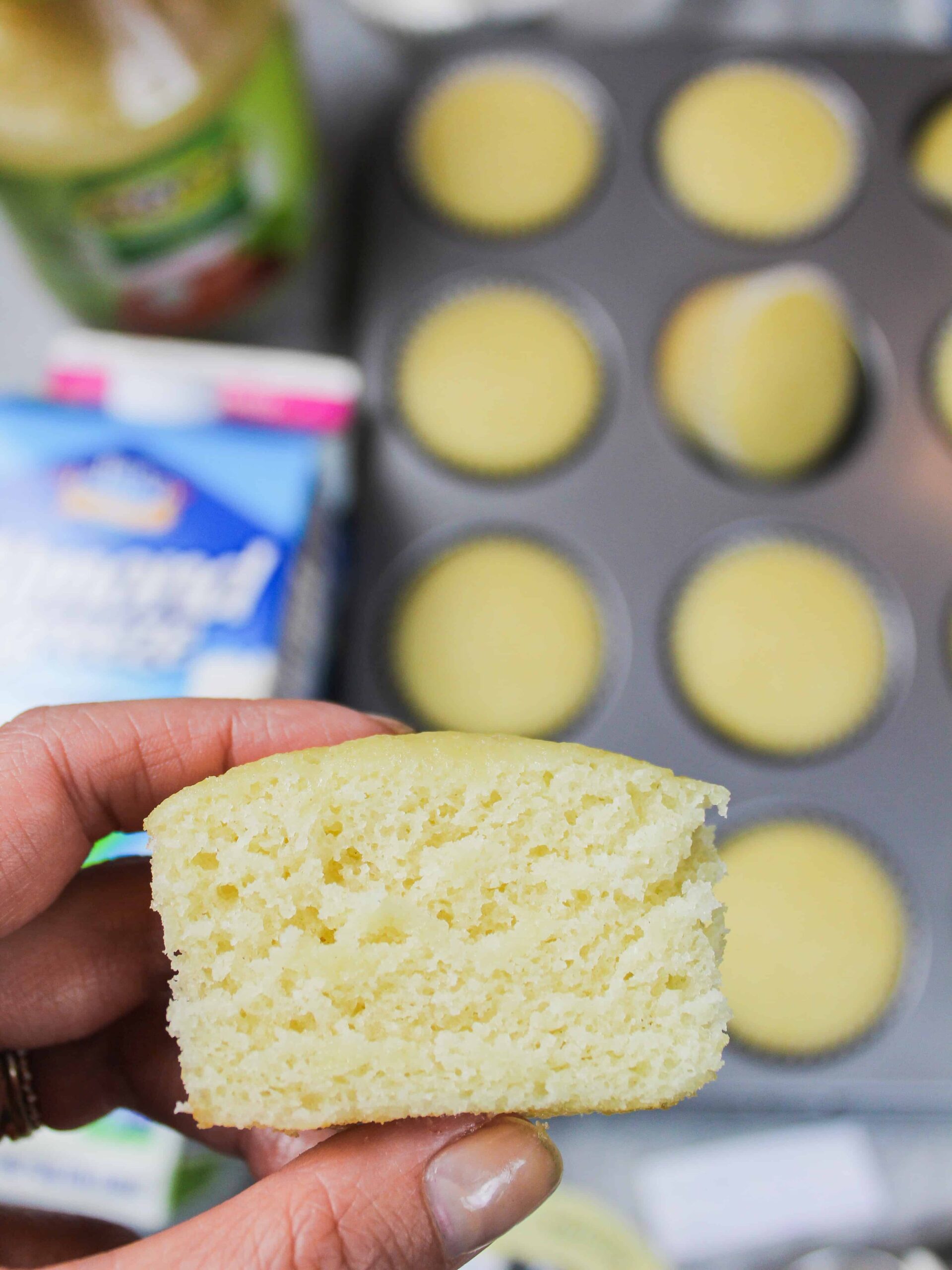 image of dairy and egg free cupcake, cut in half to show how tender and moist the cupcake is