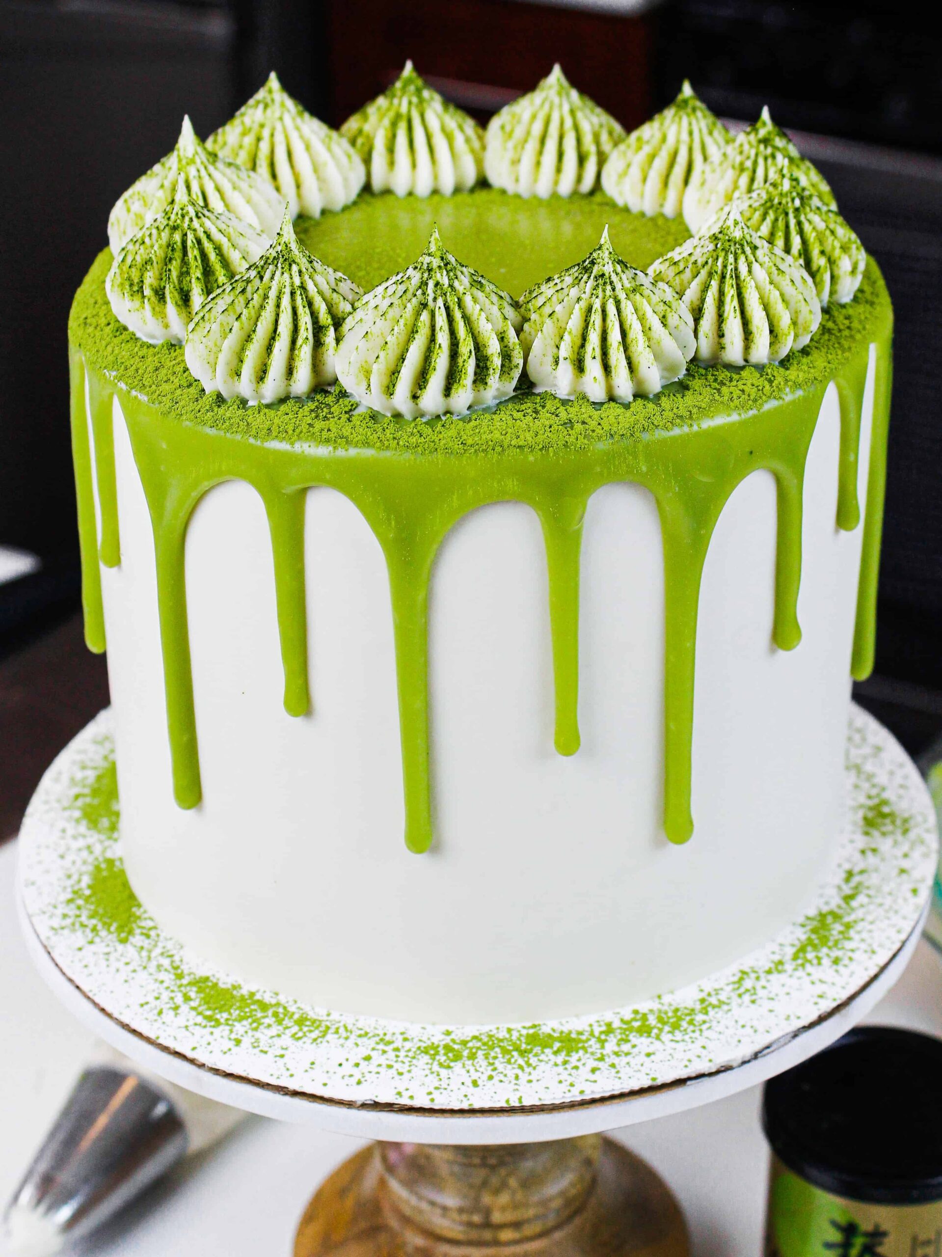 image of matcha cake on a wooden cake stand