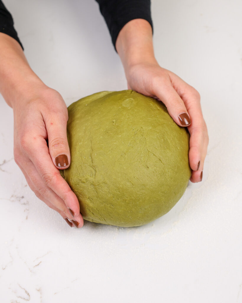 image of matcha cinnamon roll dough that's been rested and is ready to be rolled out